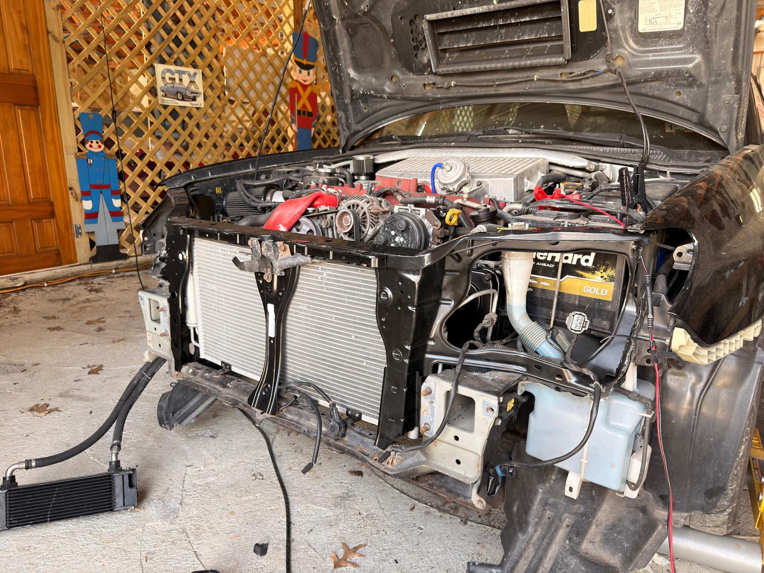 Installed the replacement front end pieces. (Left side radiator support, right side radiator support and lock support.) — photo 1