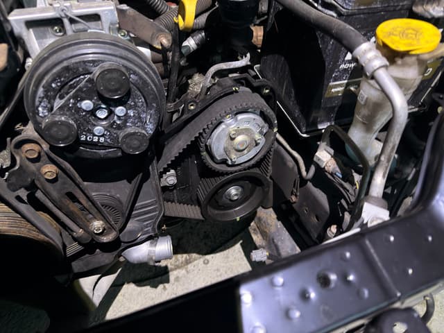 Photo from build update: Replacing the timing belt cover that was damaged from the wreck