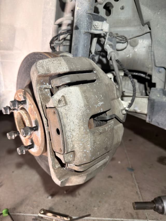 Old owner drove the brakes till it ground the sensor into dust. Replaced the pads and sensor. — photo 2